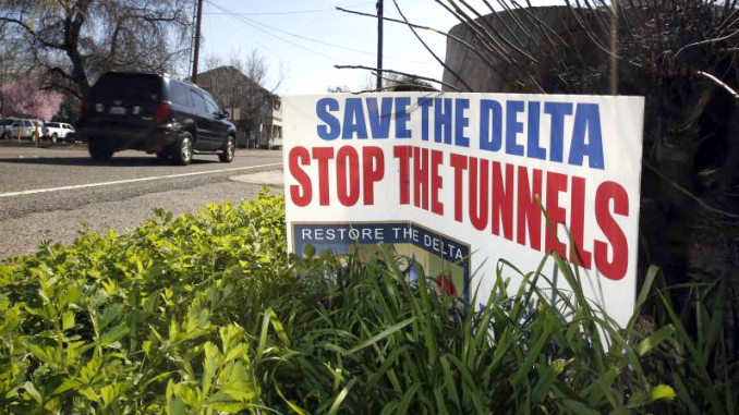 In this Feb. 23, 2016, file photo, a sign opposing a proposed tunnel plan to ship water through the Sacramento-San Joaquin Delta to Southern California is displayed near Freeport, Calif. AP photo.