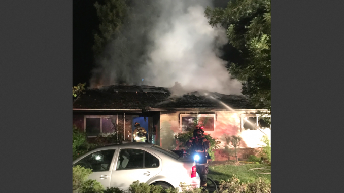 Firefighters pour water on a house on Hawthorne Avenue in Los Altos. Photo courtesy of the Santa Clara County Fire Department.
