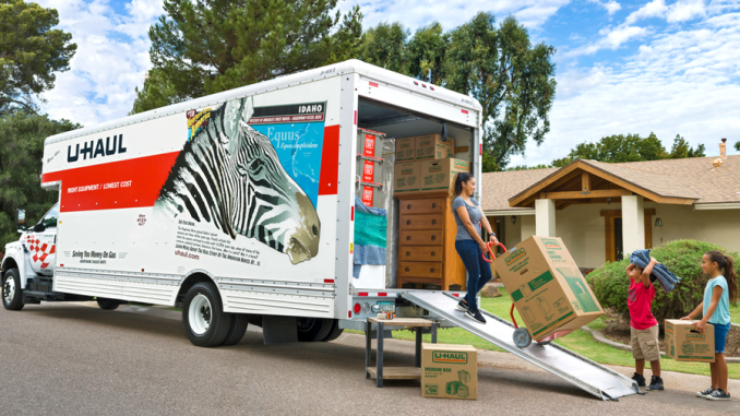 Family packs their belongings in a U-Haul truck. File photo.