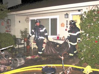 Firefighters remove damaged items from a house at 298 Beresford Ave. in unincorporated Redwood City. Photo provided by the Menlo Park Fire Protection District.