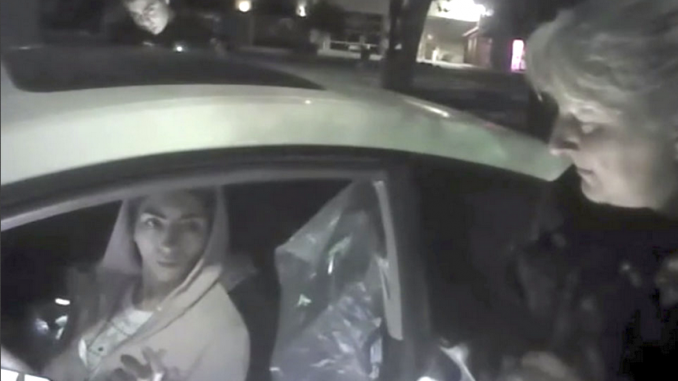 In this April 3, 2018 image from video provided by the Mountain View Police Department, Nasim Aghdam is questioned by officers after being found asleep in her car in Mountain View's Walmart parking lot. The newly-released police body camera video was made hours before she opened fire at YouTube's headquarters in San Bruno.