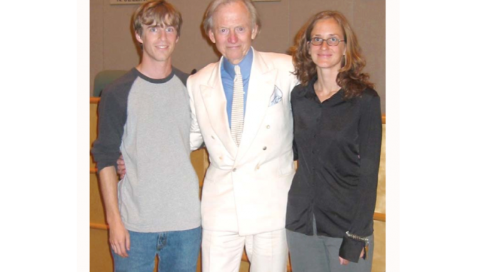 Tom Wolfe poses with Jenny Davis, a former events coordinator at Kepler’s Books, and another Kepler's employee at a 2004 bookstore event. Photo courtesy of Kepler's CEO Praveen Madan.