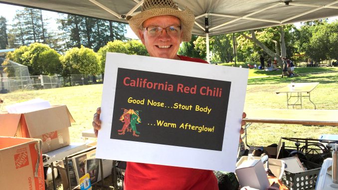David Chase holds up a sign for the team California Red — the first place winner at the 37th annual Palo Alto Chili Cook-Off. Chase and his chili partner, Robert McDonald, served up over 30 gallons of chili. Post photo by Emily Mibach.