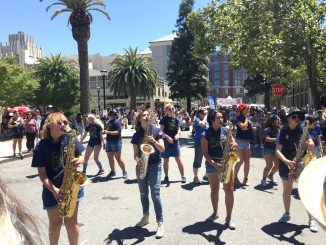 At the Redwood City Independence Day Celebration, the Stanford and UC-Davis marching bands played their hearts out during the two-hour battle of the bands, where saxophonists and other musicians performed among the crowd at times. Post photo by Emily Mibach.