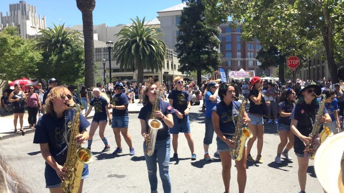 At the Redwood City Independence Day Celebration, the Stanford and UC-Davis marching bands played their hearts out during the two-hour battle of the bands, where saxophonists and other musicians performed among the crowd at times. Post photo by Emily Mibach.