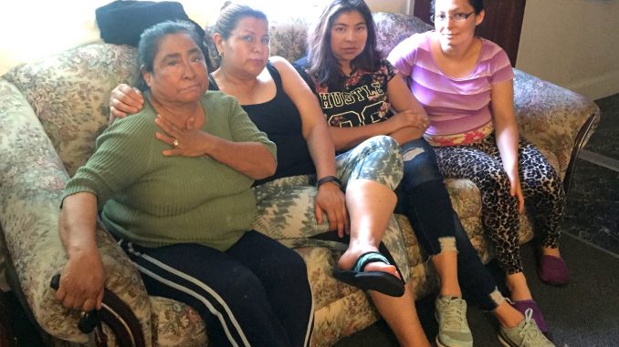 From left, tenants Teresa Rivas, Eisabel Coronel, Lilian Flores and Sandra Zamora sit in Zamora’s 430-square-foot apartment at 505 Pierce Road in Menlo Park’s Belle Haven neighborhood, located about a mile away from Facebook’s expansion on Constitution Drive. Post photo by Emily Mibach.