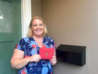 Kristen Podulka holds one of the cards she’s received in support of Christine Blasey Ford. Post photo by Allison Levitsky.