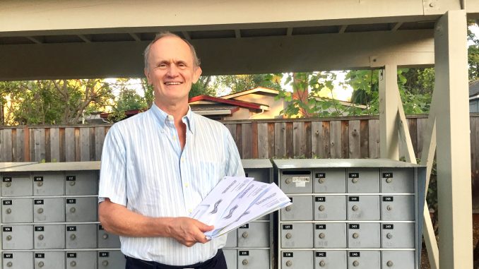 Steve Chandler holds the three ballots he got in the mail from Santa Clara County. Post photo by Allison Levitsky.
