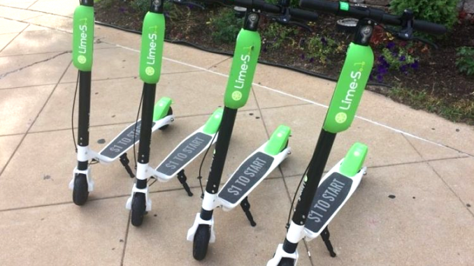 Lime and other companies leave their scooters on sidewalks and other public places, hoping somebody will want to grab one and pay the fee to take a ride. File photo.