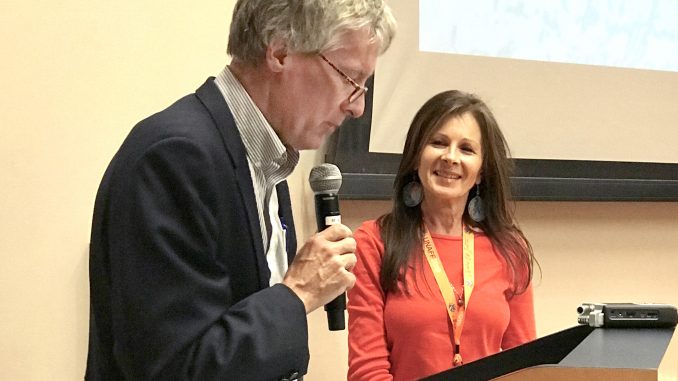 Palo Alto Mayor Eric Filseth delivers the opening remarks at the 22nd United Nations Association Film Festival at the Mitchell Park Community Center as festival founder Jasmina Bojic stands at his side. Post photo by Sara Tabin.